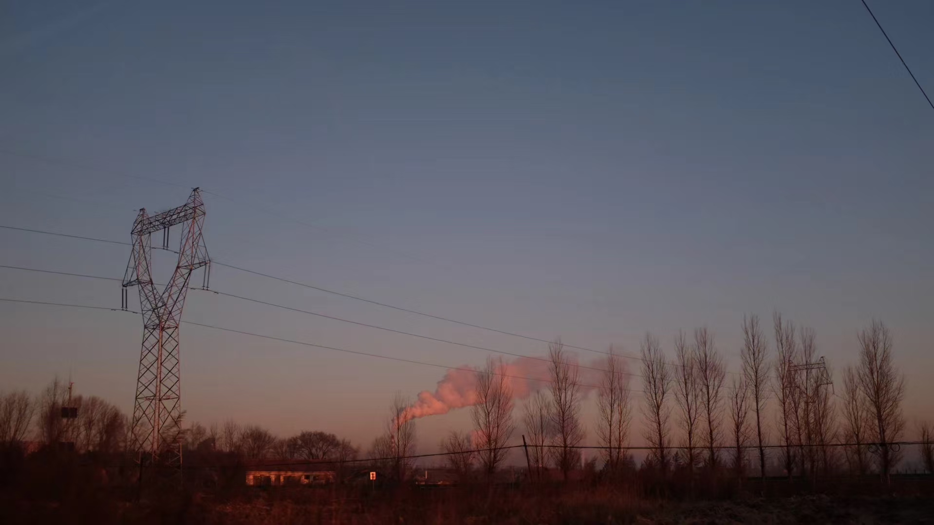 Powerline tower and dusk smoke
