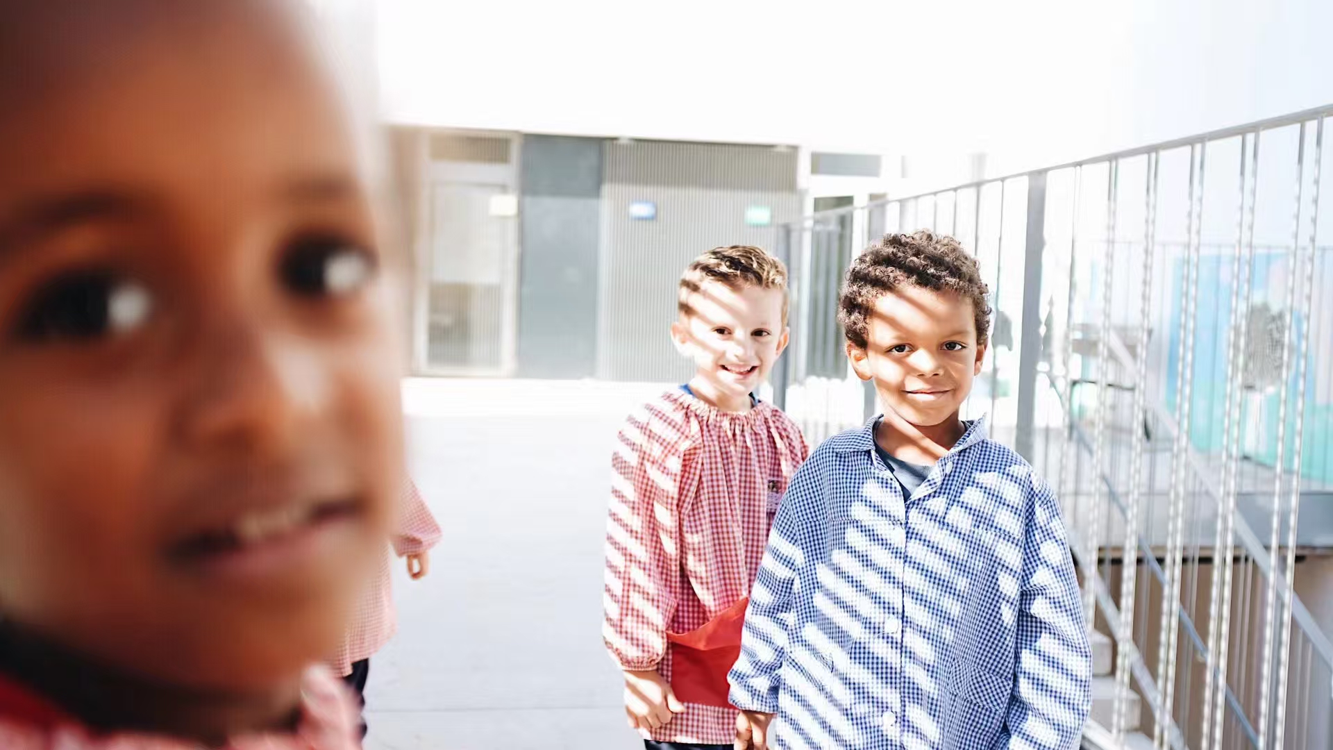 Children standing in bright sunlight